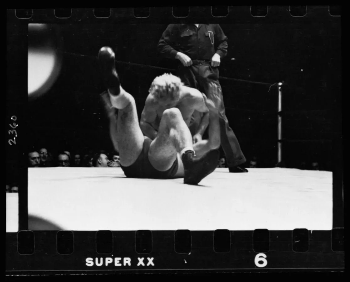Luchador derribado sobre la lona del ring